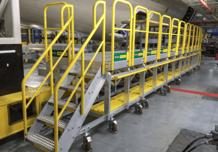 MP work plarform with guard rails on one side for working along the under side of the fusalage of an airplane 705x492 Rolling Stairs and Work Platforms